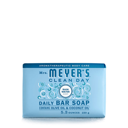 Mrs. Meyers Bar Soap in a rectangular blue package features a Rain Water scent, weighs 5.3 oz (150g), and is enriched with olive and coconut oils. Its garden-inspired, adorned with bubbles, and Leaping Bunny certified for cruelty-free assurance.