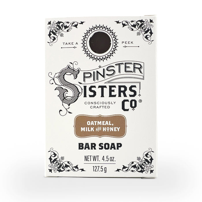 The Spinster Sisters Co. Bar Soap in Oatmeal, Milk & Honey is 4.5 oz (127.5 g), featuring moisturizing properties and a rectangular white box with decorative black text and floral designs.