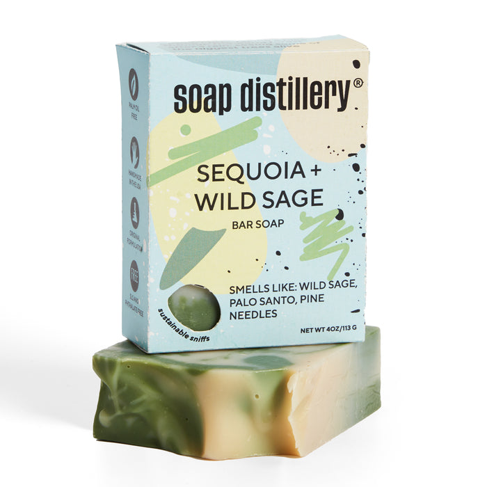 Soap Distillerys palm oil-free Bar Soap is scented with wild sage, palo santo, and pine needles. The marbled green and beige soap features abstract green and beige packaging designs.