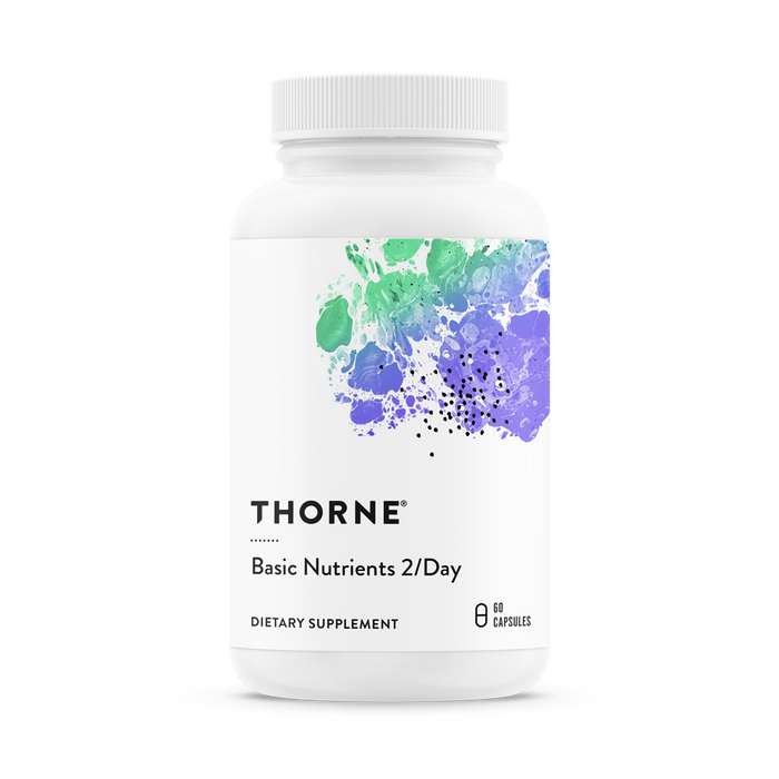 A white bottle of Thornes Basic Nutrients 2/Day daily multi, offering comprehensive nutritional support with 60 capsules, features a label with abstract splashes of green, blue, and purple paint.