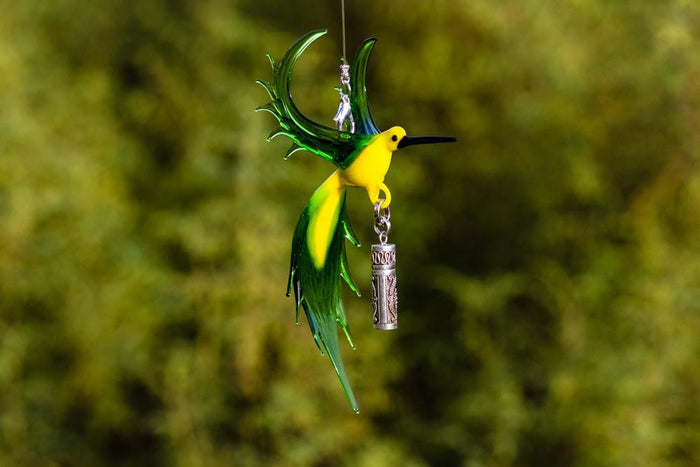 Glass bee eater ornament with a sterling silver keepsake urn pendant dangling from the bird.