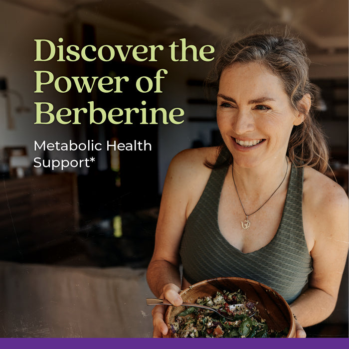 A woman with long hair smiles while holding a bowl of salad. The text reads "Discover the Power of Berberine" and "Metabolic Health Support*". The setting is a warmly lit indoor space.