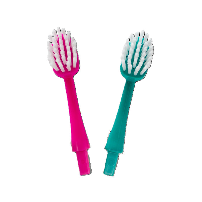 The Radius Big Kidz® Forever Brush™ 2 Pack Replacement Heads, featuring pink and teal options with white bio-based bristles, are displayed side by side on a white background for a deeper clean.