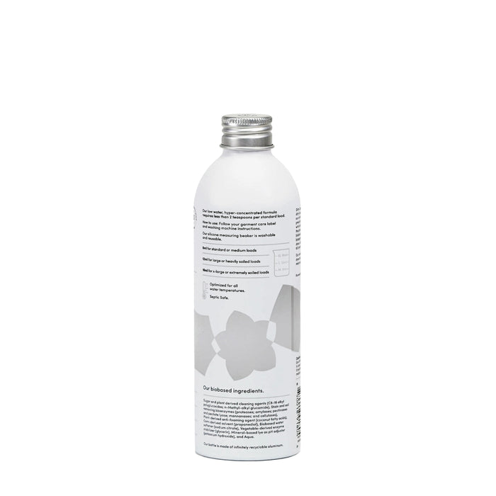 A white cylindrical bottle with a silver cap, featuring minimalistic text and abstract grey shapes on the label. This Dirty Labs Bio Laundry Detergent with Phytolase® - Free & Clear is positioned upright against a plain white background.