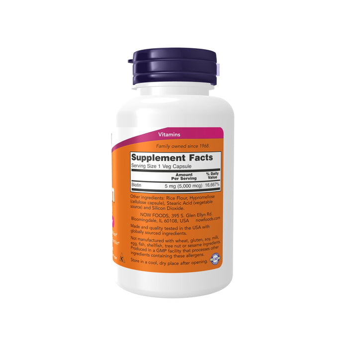 A white supplement bottle with a purple cap labeled Supplement Facts for Biotin 5000 mcg per serving—ideal for skin health. Ingredients: rice flour, silicon dioxide. Made in the USA by family-owned NOW Foods.
