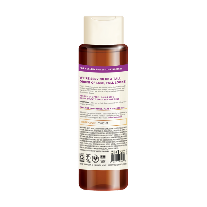 Soapboxs Biotin and Superfruit Restore & Volumize Shampoo, with a purple label and white cap, promotes healthy, fuller-looking hair. The vegan, sulfate-free formula comes with a barcode and ingredients list on the label.