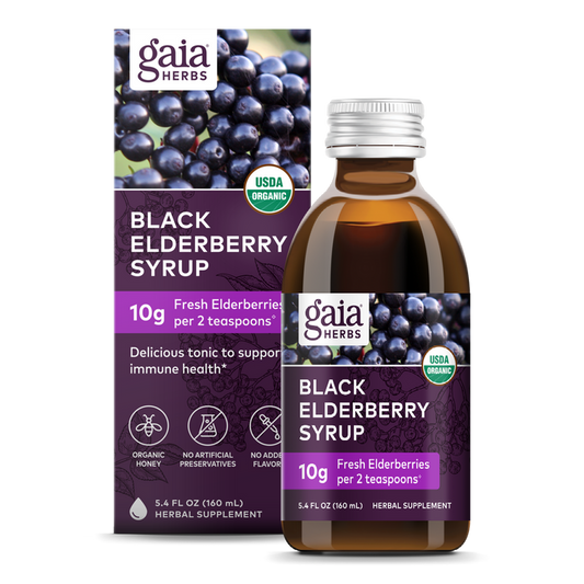 A Gaia Herbs Black Elderberry Syrup bottle and box highlight 10g of organic black elderberries per 2 tsp. The USDA organic label ensures no artificial preservatives or flavors, with the box featuring elderberries for immune support.