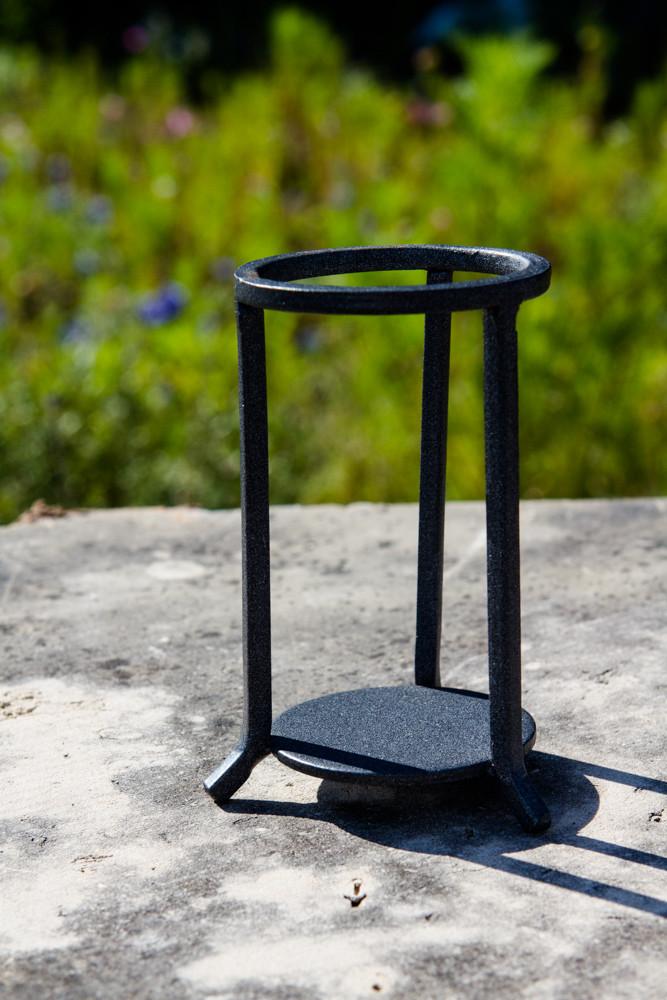 Black wrought-iron three-leg stand for displaying a 3-inch diameter orb; 4 inches tall and 2 inches wide.