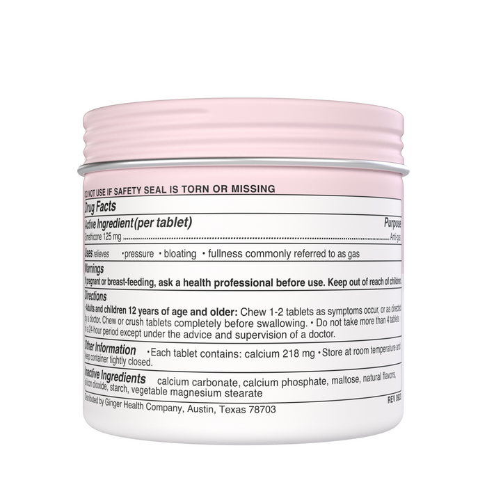 A round container with a pink lid features a label revealing drug facts for antacid tablets, including dosage instructions, warnings, and ingredients like calcium carbonate. The product name is Bloat + Gas by Wonderbelly, primarily used for gas and bloat relief like Simethicone Tablets.