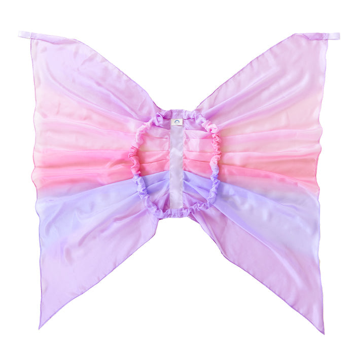 The Blossom Fairy Wings by Sarahs Silks are crafted from soft, translucent fabric in pastel pink, purple, and lavender. Reminiscent of mulberry silk, the symmetrical design includes a textured finish and central elastic strap for dress-up play.