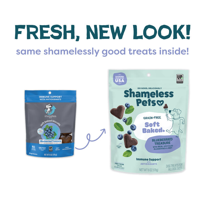 Two bags of Shameless Pets Blueberried Treasure Soft-Baked Dog Treats are shown, featuring upcycled ingredients. The blue-gray and mint green bags read: FRESH, NEW LOOK! same shamelessly good treats inside! Heart-shaped treats shown.
