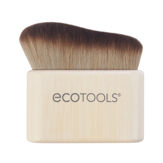 The EcoTools Body + Face Self-Tan Blending brush features dense, soft bristles that fade from dark brown to light beige. Its rectangular, round-edged handle is crafted from light wood and displays the EcoTools logo. This cruelty-free, vegan brush ensures a streak-free tan application.