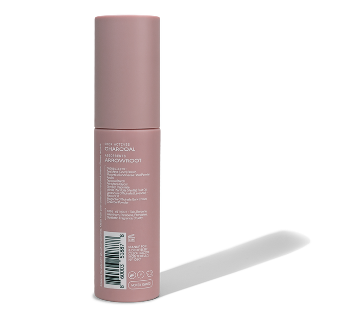 A pink cylindrical container of Cleo & Coco Body + Hair Powder, featuring an aluminum-free formula with natural arrowroot powder, stands upright on a white background showing the back label with product information and barcode.