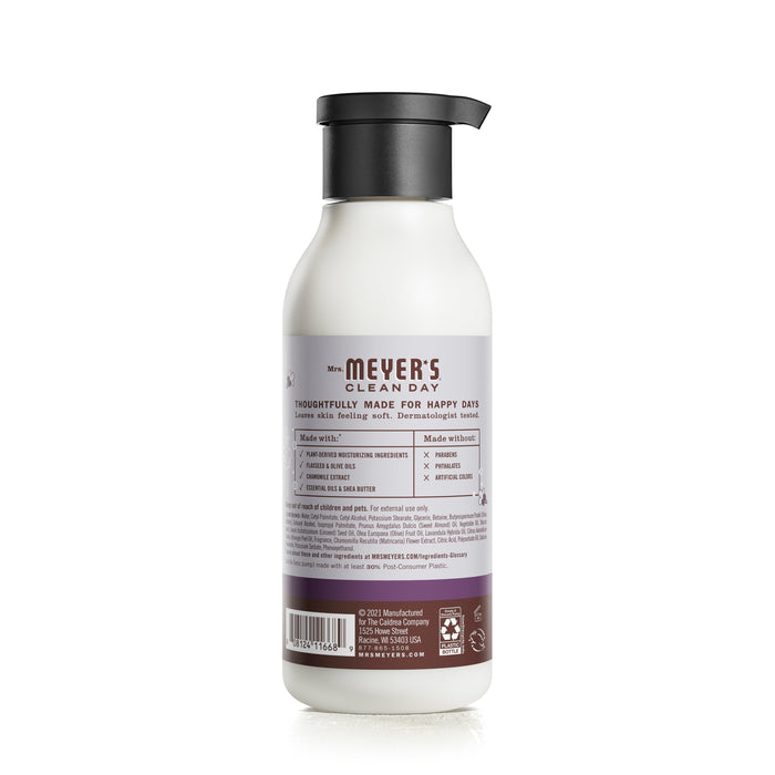 A bottle of Mrs. Meyers Body Lotion with a black pump cap sits elegantly. The back label highlights garden-inspired scents and naturally derived ingredients, detailing benefits, usage instructions, and more in various fonts and colors.