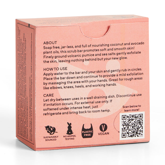 The image shows the back of Soap Distillerys pink Body Scrub Bar box. It features icons for exfoliation, sustainable sourcing, being plastic-free, cruelty-free, and vegan. Uses and care instructions are detailed along with a QR code on the right side.