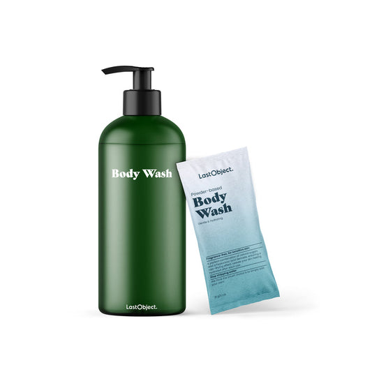 A LastObject Body Wash Starter Set in a green bottle is beside a blue packet of Powder-based Body Wash, both utilizing natural sugars in their innovative skincare.
