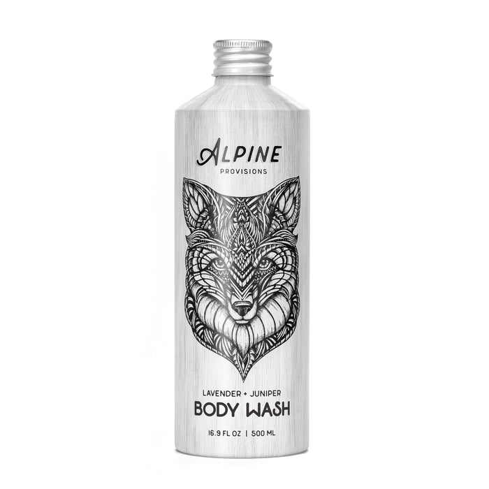 A 16.9 fl oz (500 ml) metallic bottle of Alpine Provisions Body Wash features a black and white fox illustration and is infused with essential oils, labeled Lavender + Juniper.
