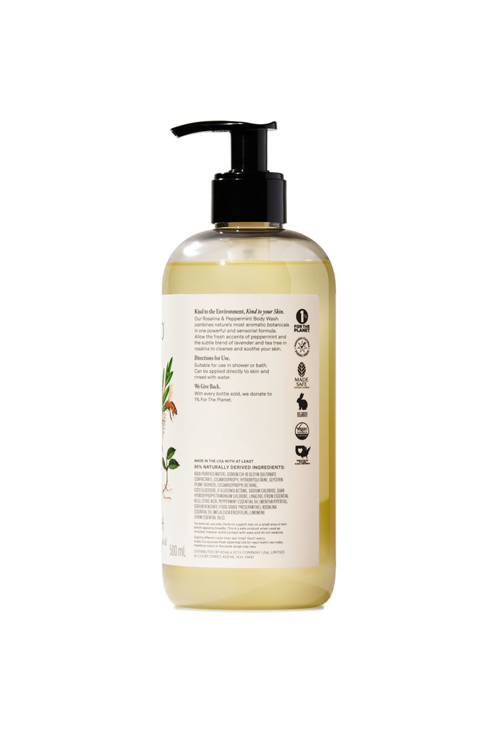 A clear bottle of Koala Eco Body Wash with a black pump dispenser holds yellow liquid. The white label features eco-friendly icons, text, and a botanical Rosalina illustration.