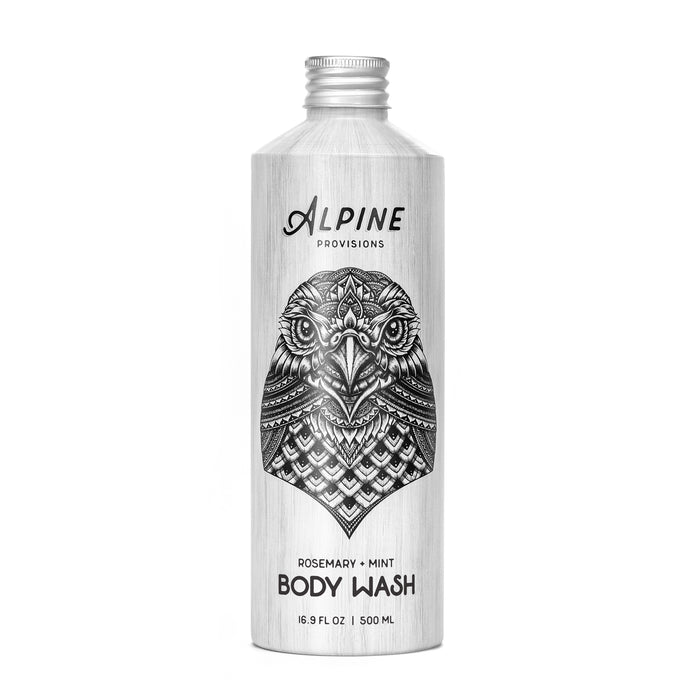 A 16.9 FL OZ silver Alpine Provisions Body Wash bottle, adorned with a black eagle illustration, features a rich blend of essential oils. The label reads Rosemary + Mint, reflecting its natural ingredients inspired by the Alpine forest.