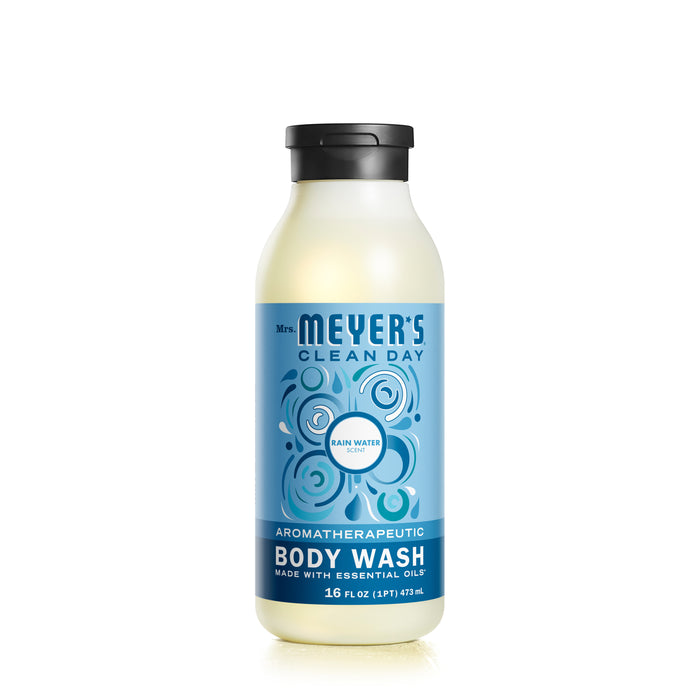 A 16 oz bottle of Mrs. Meyers Body Wash features a blue label with circles, showcasing Rain Water and Aromatherapeutic Body Wash. Enriched with essential oils, it emphasizes an environmentally friendly formula.