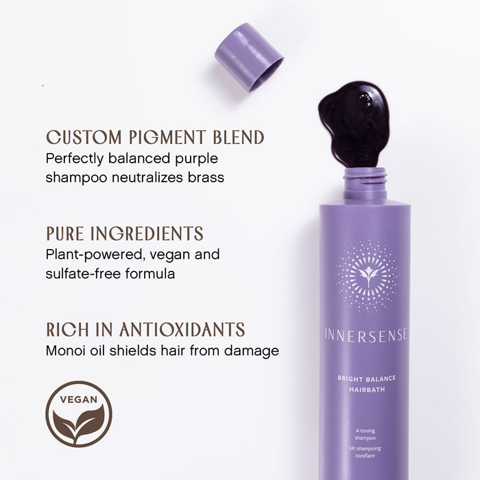 A purple shampoo bottle labeled "Innersense Bright Balance Hairbath" with dark liquid spilling from the cap. Text highlights features: custom pigment blend, pure ingredients, and antioxidant-rich formula. Vegan logo included.