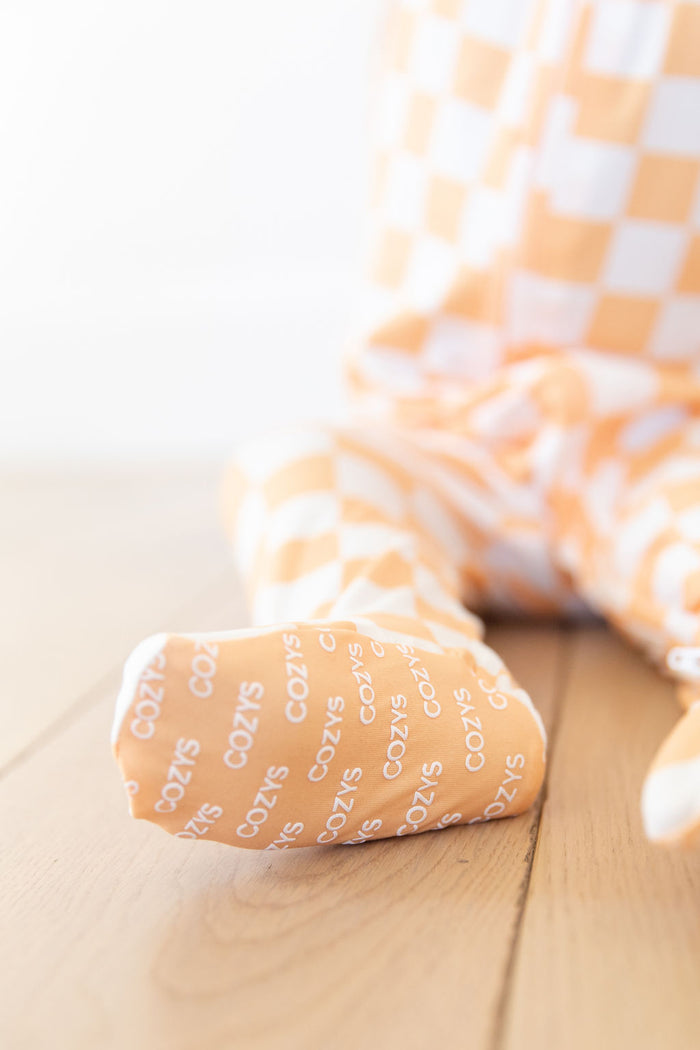 BRIGHT ORANGE + WHITE CHECKER | FOOTIE ONE PIECE