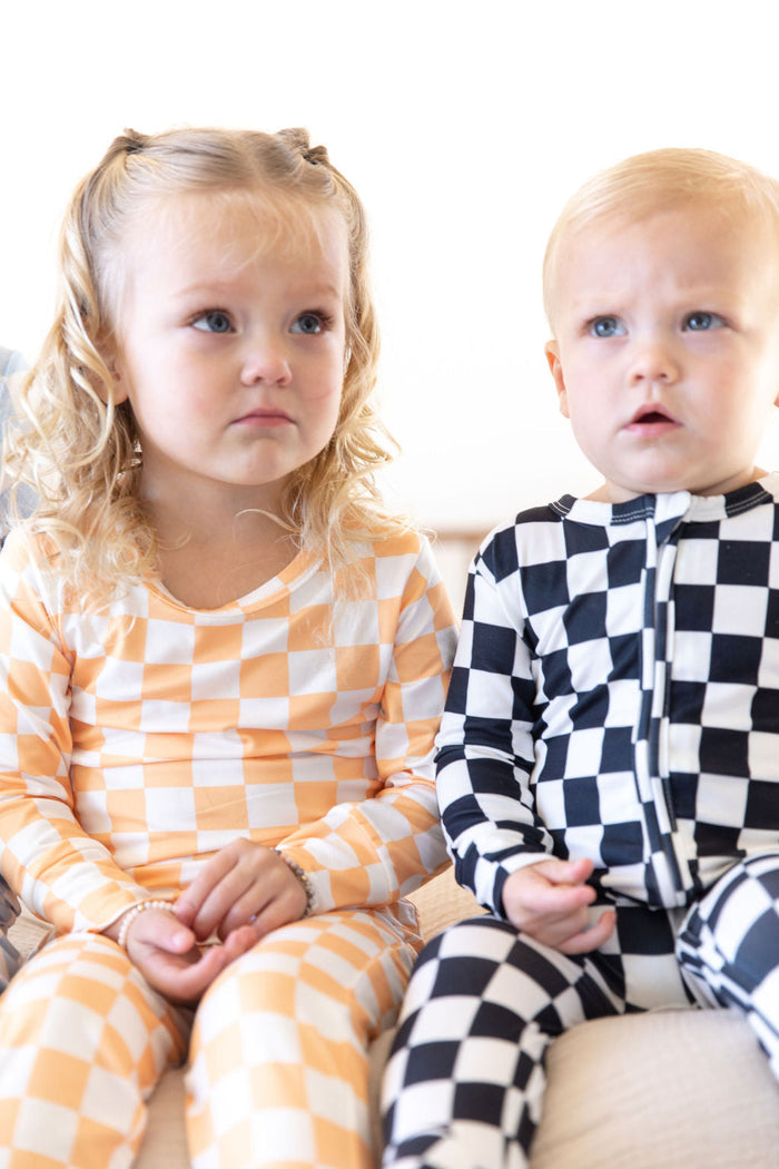BRIGHT ORANGE + WHITE CHECKER | FOOTIE ONE PIECE