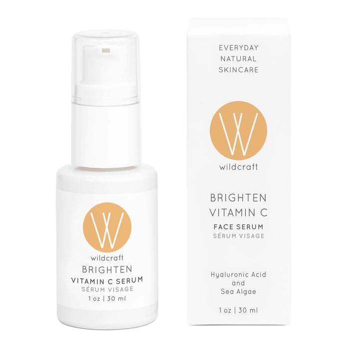 A sleek white bottle and box of Wildcraft Brighten Vitamin C Face Serum feature a pump dispenser and logo, showcasing its formula with hyaluronic acid and sea algae for radiant skin.