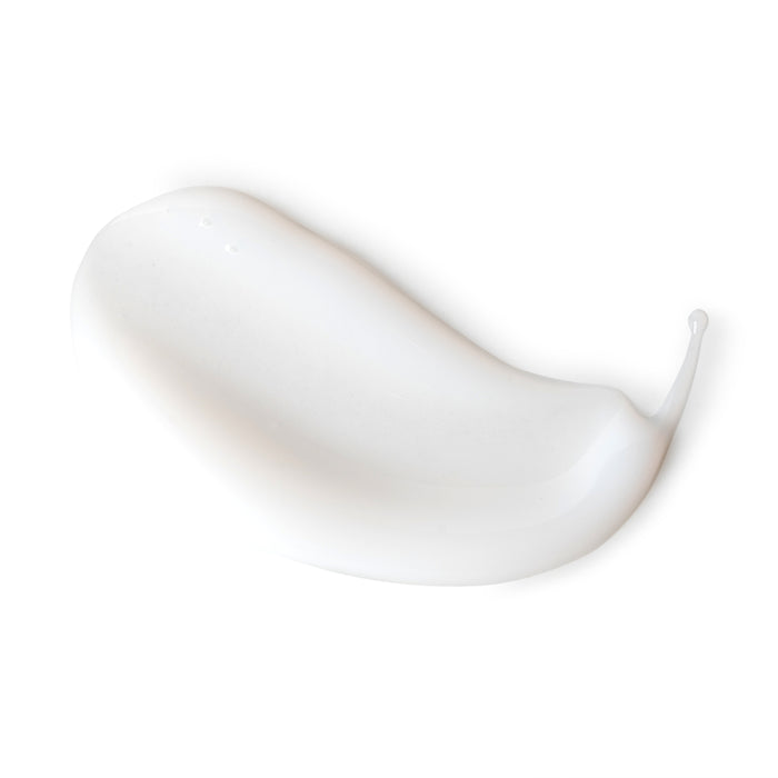 A close-up of a smooth, glossy swatch of Andalou Naturals Brightening Meyer Lemon + C Creamy Cleanser on a white background. The creamy texture forms a soft, curved shape.