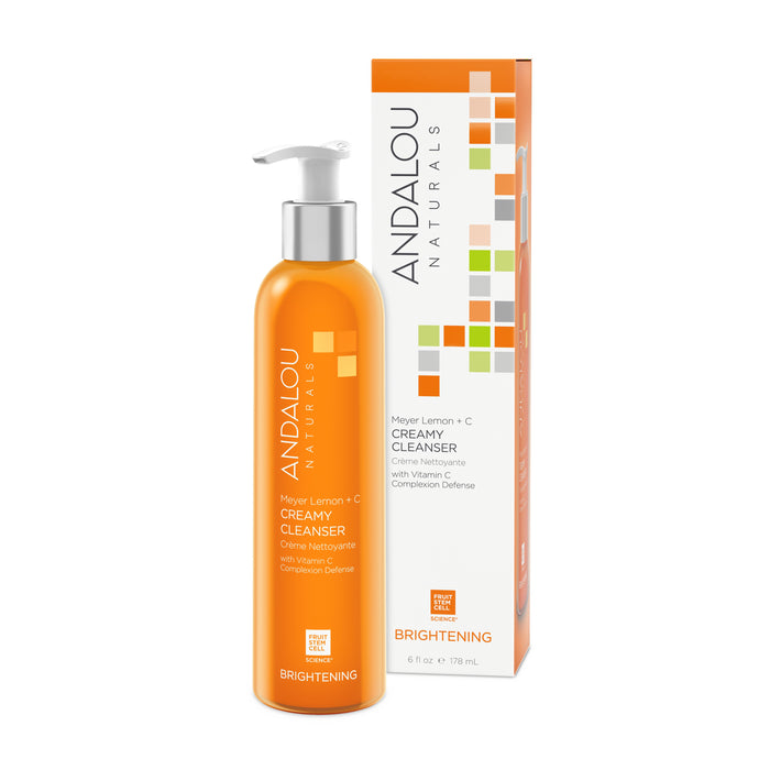 An Andalou Naturals Brightening Meyer Lemon + C Creamy Cleanser bottle with its box. The orange packaging showcases a white pump and vibrant geometric patterns, highlighting skin-brightening benefits and pollution defense with vitamin C in this Meyer Lemon cleanser.