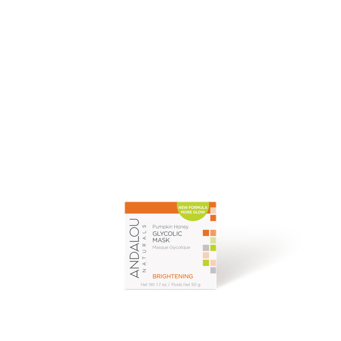 A small box of Andalou Naturals Brightening Pumpkin Honey Glycolic Mask, with orange, green, and white accents and labeled "NEW FORMULA, MORE GLOW," features glycolic acid for radiant skin on a white background.
