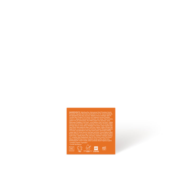 An orange square box of Andalou Naturals Brightening Pumpkin Honey Glycolic Mask features white ingredient text and symbols, centered on a plain white background. The small print is mostly unreadable due to the image resolution.