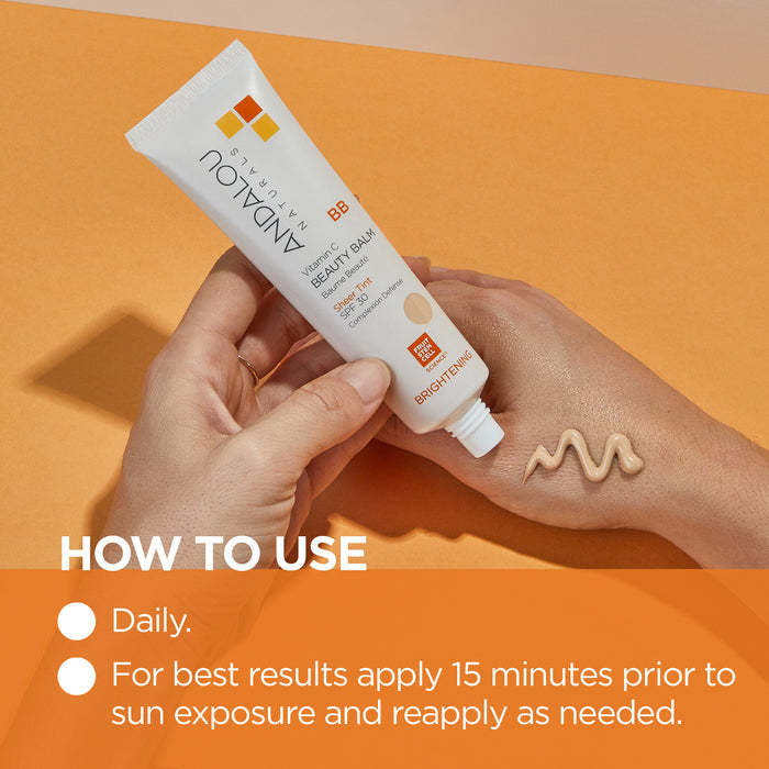 A person squeezes a tube of BB cream onto the back of their hand. The tube is labeled "Endalou Naturals." The image background is orange, and text instructions are present for applying the cream daily before sun exposure.