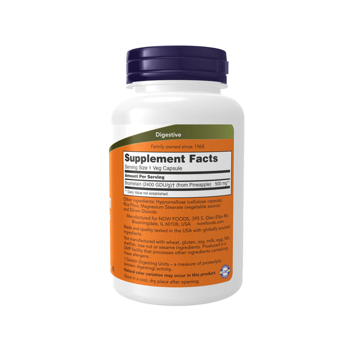 A white bottle of NOW Foods Bromelain 500 mg, a digestive supplement, features an orange label with black and white text and a blue cap. Each capsule contains 500 mg of bromelain for digestion support. The label includes Supplement Facts with ingredients and manufacturer details.