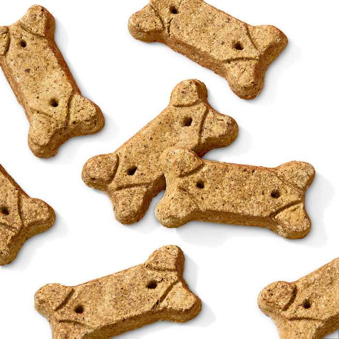 Brutus Broths Brutus Bone Broth Biscuits scatter on a white background. These light brown, bone-shaped treats are enriched with real meat and feature small surface holes, resembling classic dog snacks.