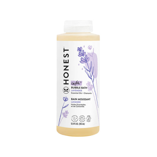 A 12 fl oz (355 ml) bottle of The Honest Companys Bubble Bath features lavender essential oils and chamomile extract. The label has purple lavender illustrations on a white background for a calming bathing experience.
