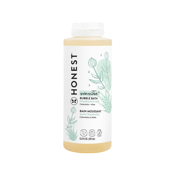 A 12 fl oz bottle of The Honest Companys Bubble Bath features a white label with green plant illustrations. It offers a fragrance-free formula with calendula, aloe, and chamomile extracts for calming sensitive skin.