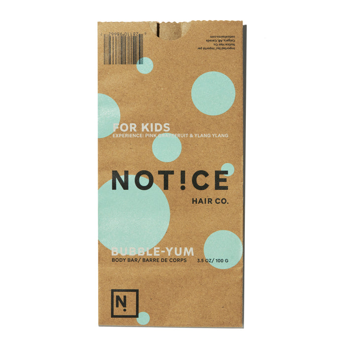 The Bubble-Yum Body Bar from NOT!CE Hair Co. comes in brown packaging with blue circles and  For Kids labels. Its a vegan, cruelty-free bar offering a playful pink grapefruit & ylang ylang scent, weighing 3.5 oz/100 g for a gentle cleanse.