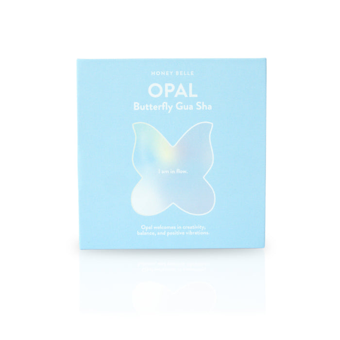 Light blue packaging for Honey Belles Butterfly Gua Sha features an abstract butterfly design with I am in flow. This ideal tool for contouring encourages creativity, balance, lymphatic drainage, and positive vibes.