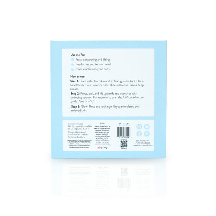 The sleek blue Butterfly Gua Sha box by Honey Belle includes a tool and instructions for optimal use, providing benefits like facial contouring, lifting, lymphatic drainage, headache relief, and muscle ache reduction. It features skin prep steps and relaxation methods with social media links and a QR code for tips.