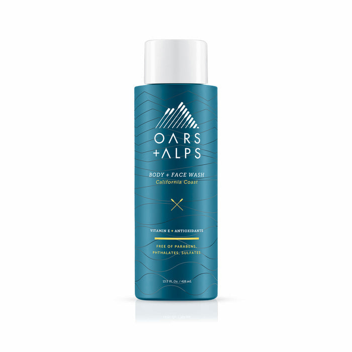A teal bottle of Oars + Alps Cali Coast Body Wash with white text and a mountain logo. The label notes Vitamin E, antioxidants, and that it’s free of parabens, phthalates, and sulfates.