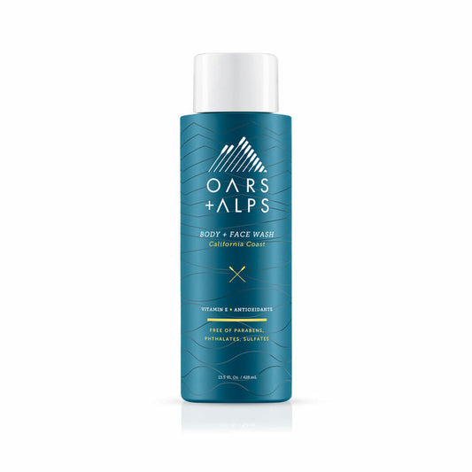 A teal bottle of Oars + Alps Cali Coast Body Wash with white text and a mountain logo. The label notes Vitamin E, antioxidants, and that it’s free of parabens, phthalates, and sulfates.