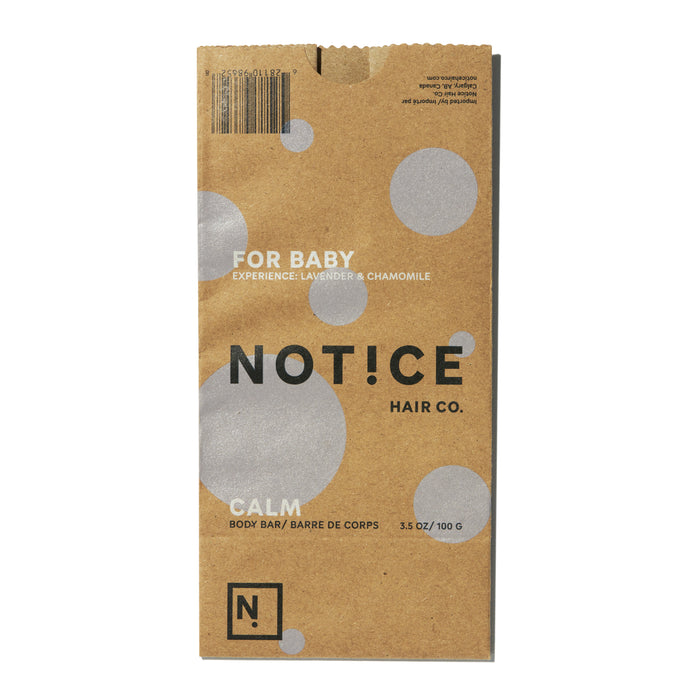 The brown cardboard packaging for the Calm Body Bar by NOT!CE Hair Co features FOR BABY, Experience: Lavender & Chamomile text. Designed for baby and sensitive skin, it showcases a sea salt formulation with circular design elements and weighs 3.5 oz/100 g.