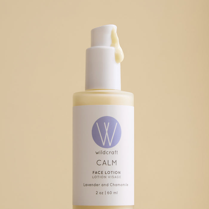 A 2 oz (60 ml) pump bottle of Wildcraft Calm Face Lotion with lightweight lotion emerging from the top, featuring lavender and chamomile on the label, sits against a beige background.