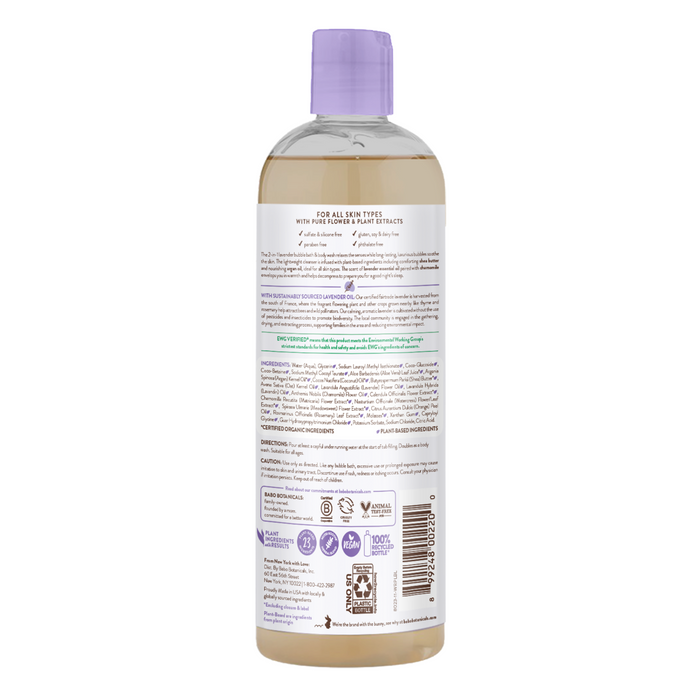 The back of the clear plastic bottle with a purple cap contains Babo Botanicals Calming Bubble Bath & Wash. The label includes usage instructions, ingredients, and recycling information. Suitable for all skin types, its calming scent is infused with lavender.