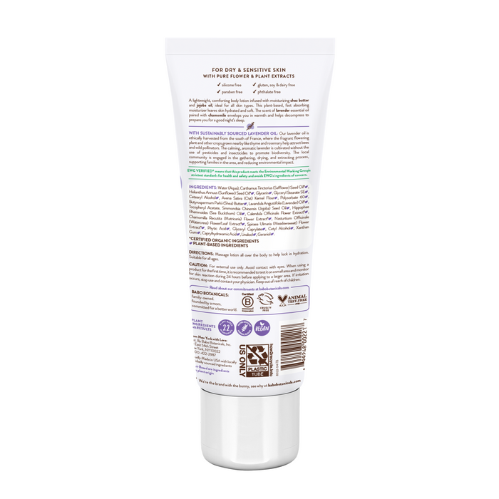 A white tube of Calming Lotion from Babo Botanicals features colorful text with usage instructions, ingredients, and certifications. Ideal for dry and sensitive skin, it emphasizes its sustainability and cruelty-free promises.