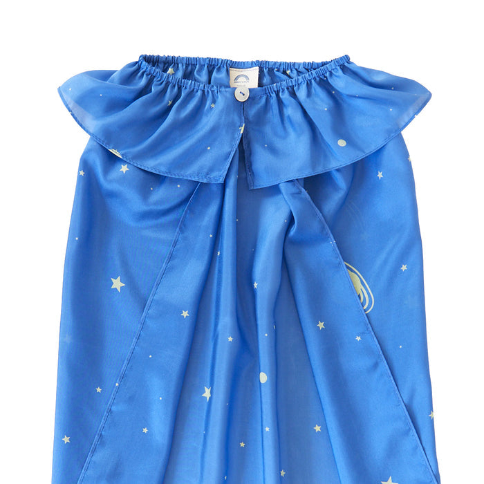 The blue childrens cape by Sarahs Silks is ideal for dress-up play, featuring a white starry pattern, lightbulb graphic, ruffled collar with a single white button closure, and a white tag inside the collar.