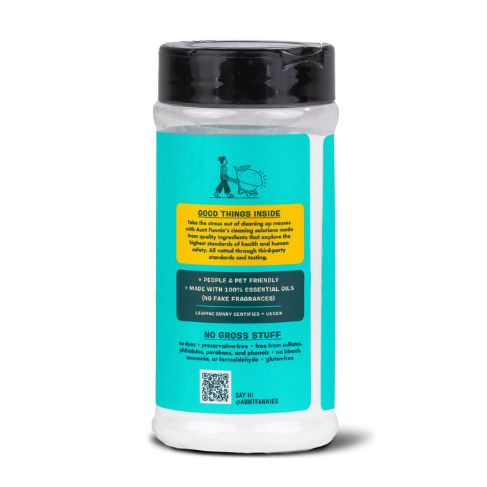 Aunt Fannies Carpet Refresher, in a teal and yellow bottle, is a vegan-friendly cleaner with essential oils. Its safe for people and pets, free from harsh chemicals, and acts as both an odor eliminator and stain remover. Find a QR code and social media handle at the bottom.