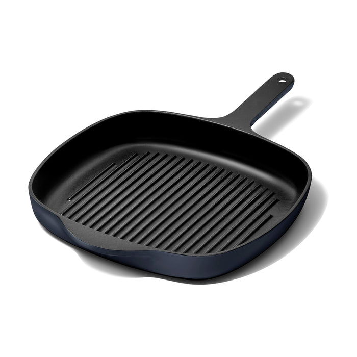 The Caraway Cast Iron Grill Pan, 10.5, features superior heat retention and a ridged surface for perfectly grilled dishes, showcased on a white background with its long handle.