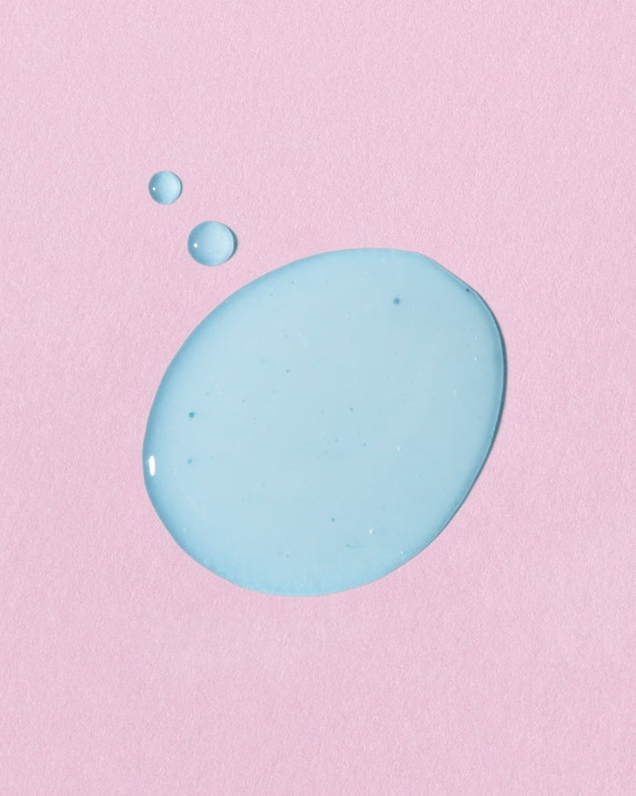 A glowing light blue droplet of the CELESTINE Hydra-Peptide Replenishing Serum by Earth Harbor is joined by two smaller droplets against a pink background.